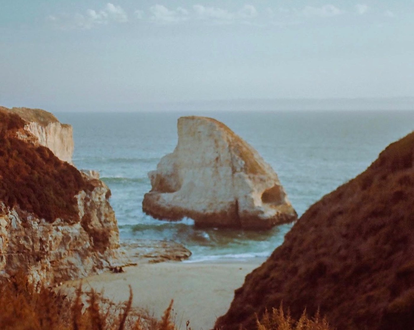 A sea stack and cliffs on the coast, shot on film