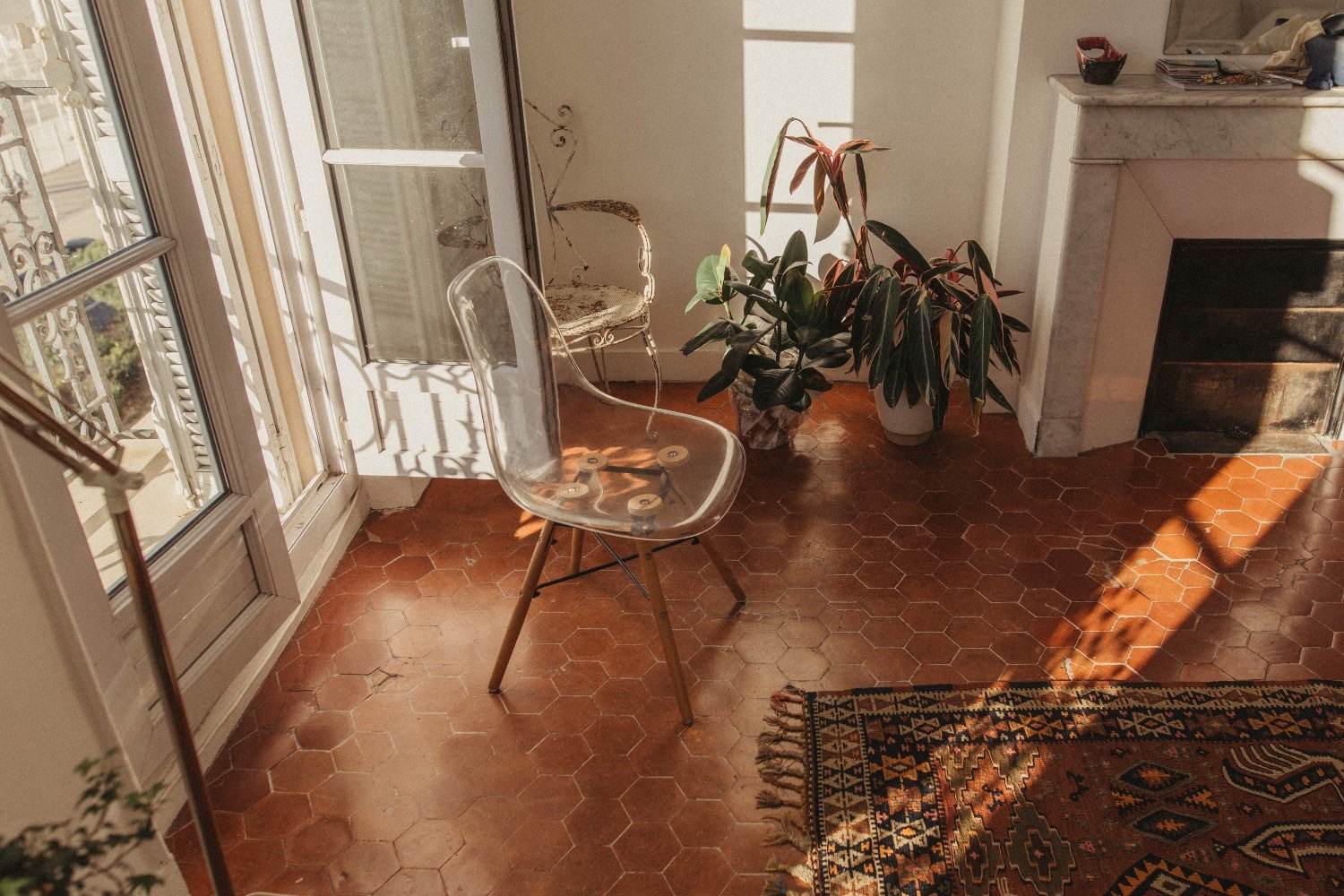 A sunlit room with a terracotta tile floor